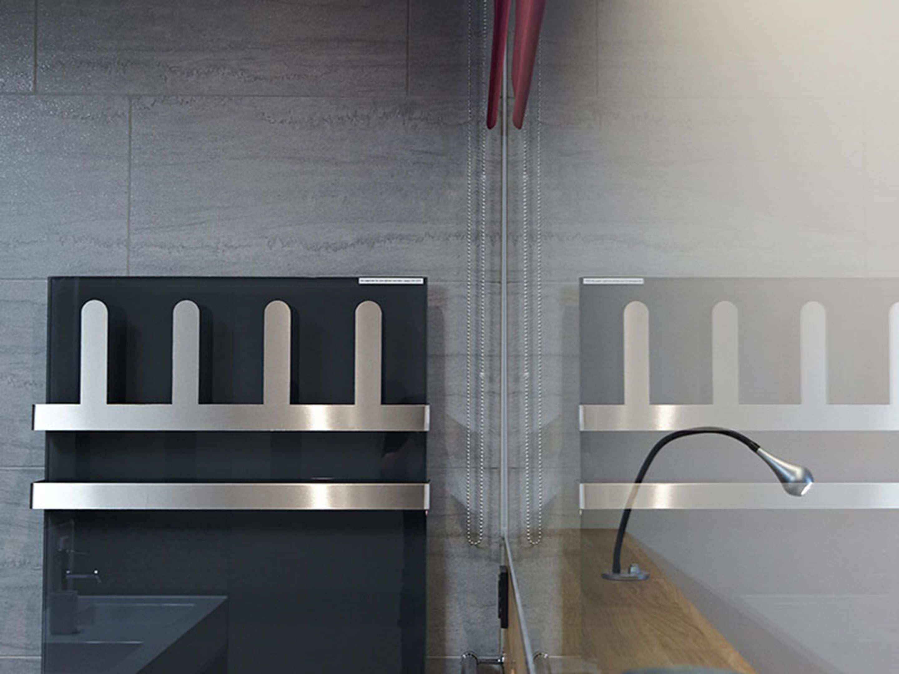 A modern kitchen with stainless steel appliances, a glass backsplash, and a wooden countertop.