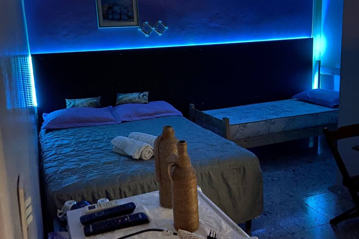 Ein Hotelzimmer mit Bett, Nachttisch und einer kleinen Sitzecke.