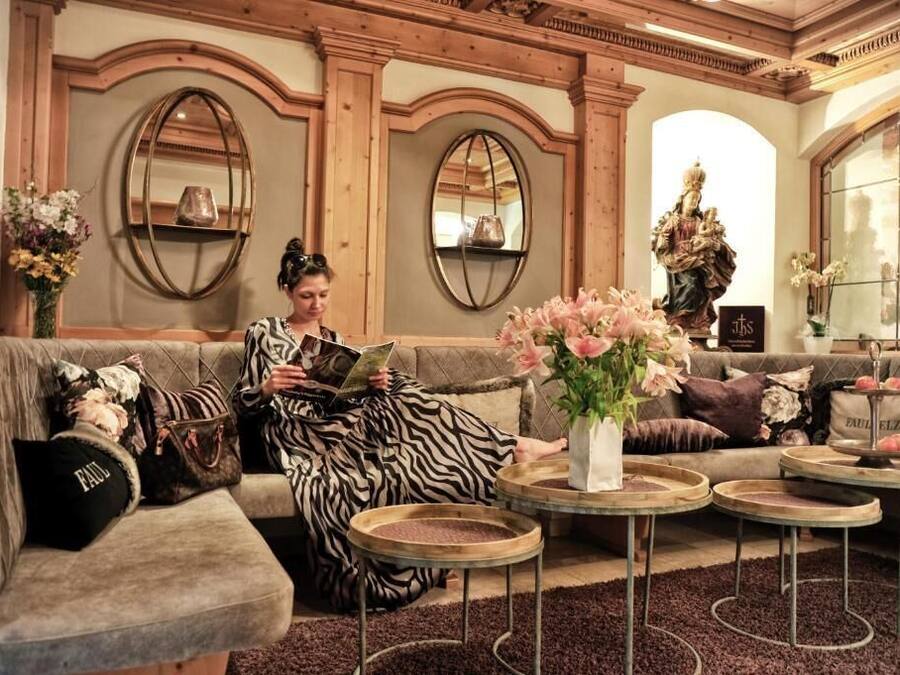 A cozy living room with a sofa, round coffee tables, and decorative items.