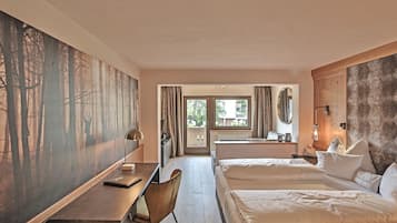A hotel room with a desk, two beds, a large painting, and a view of the outdoors.