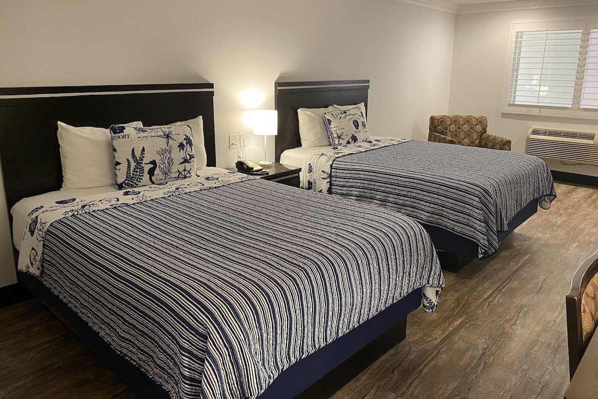 Economy Room, 2 Queen Beds, Refrigerator & Microwave | Desk, blackout drapes, iron/ironing board (on request), WiFi (free)
