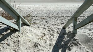 A beach with a clear sky, waves, and a sandy shore. - Seahorse Oceanfront Inn (Neptune Beach)
