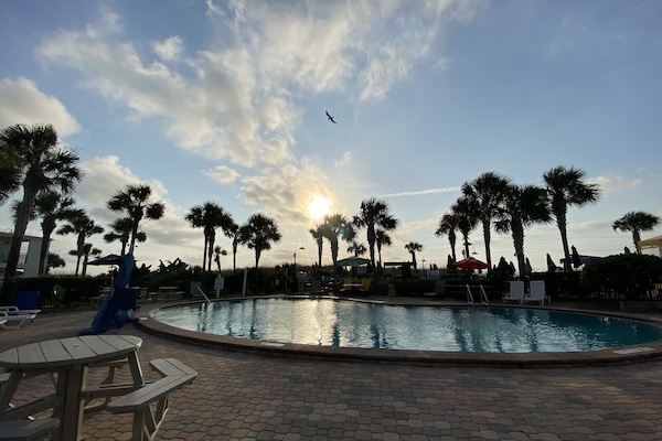 Outdoor pool, open 8:00 AM to 8:00 PM, pool umbrellas, pool loungers