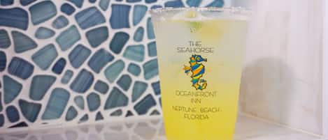 A glass with a label reading "The Seahorse" and "Oceanfront Inn, Neptune Beach, Florida" against a mosaic tile background.