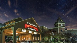 A hotel with a prominent "Welcome to Boomtown Casino Hotel" sign, a clock tower, and a drive-thru service area. - Boomtown Casino & Hotel New Orleans (Harvey)