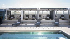 A rooftop pool area with lounge chairs and a hot tub. - Shade Hotel (Manhattan Beach)