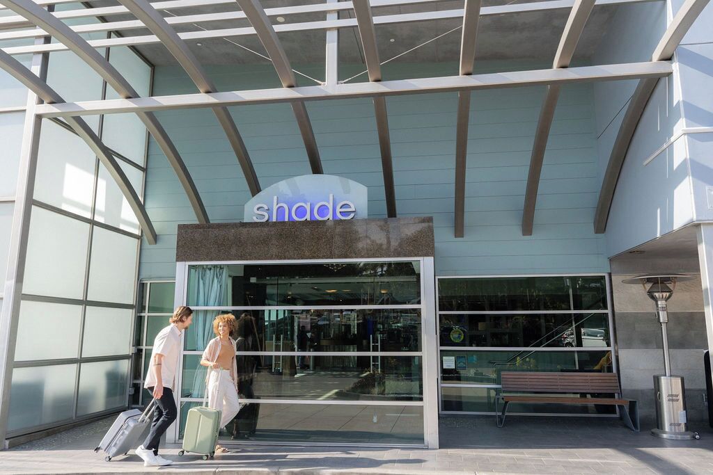 A building with a sign reading 'shade' and a glass entrance.
