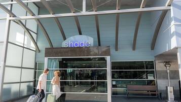 A building with a sign reading 'shade' and a glass entrance.