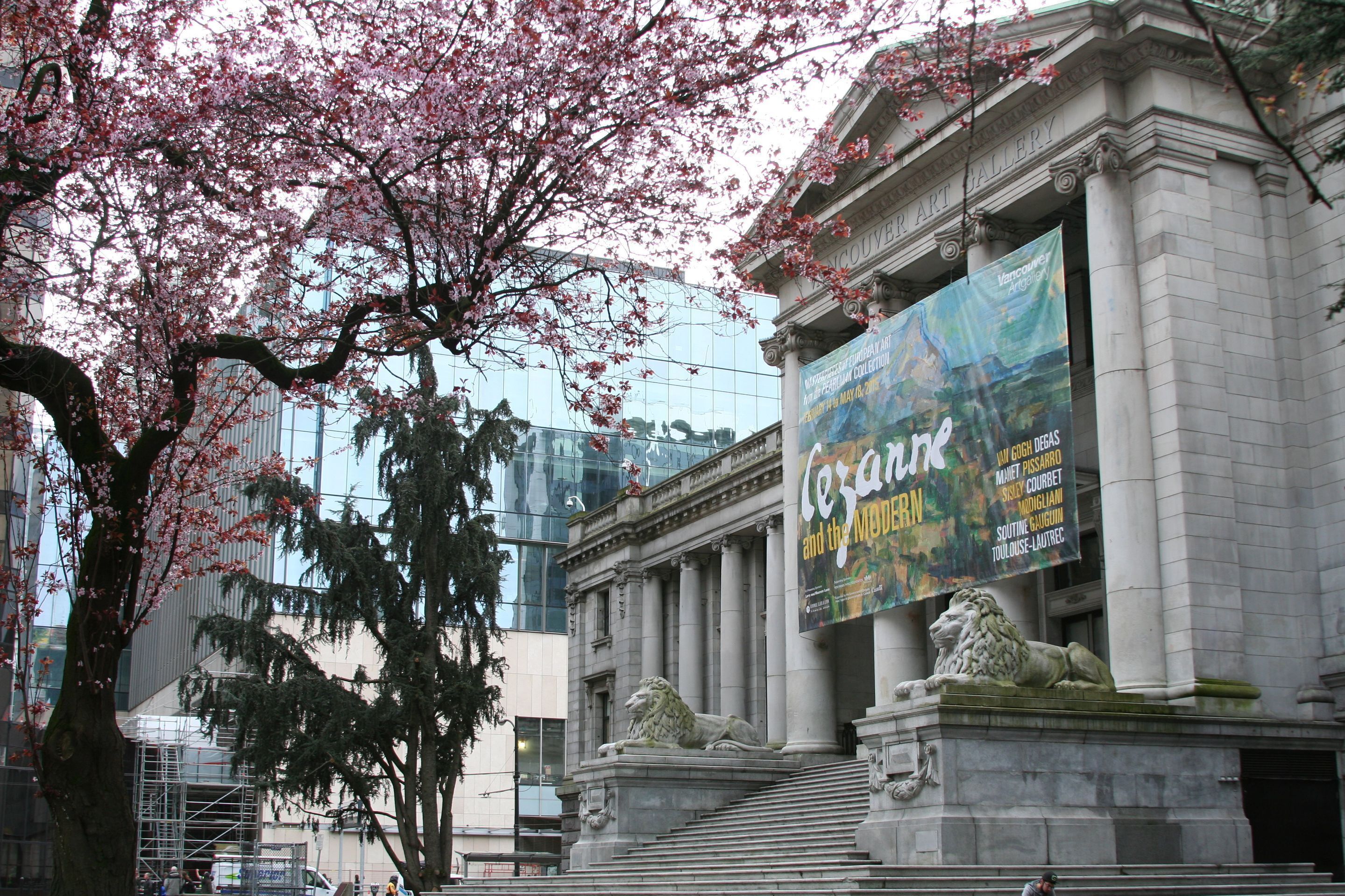 A building with classical architecture, including columns and a lion statue.