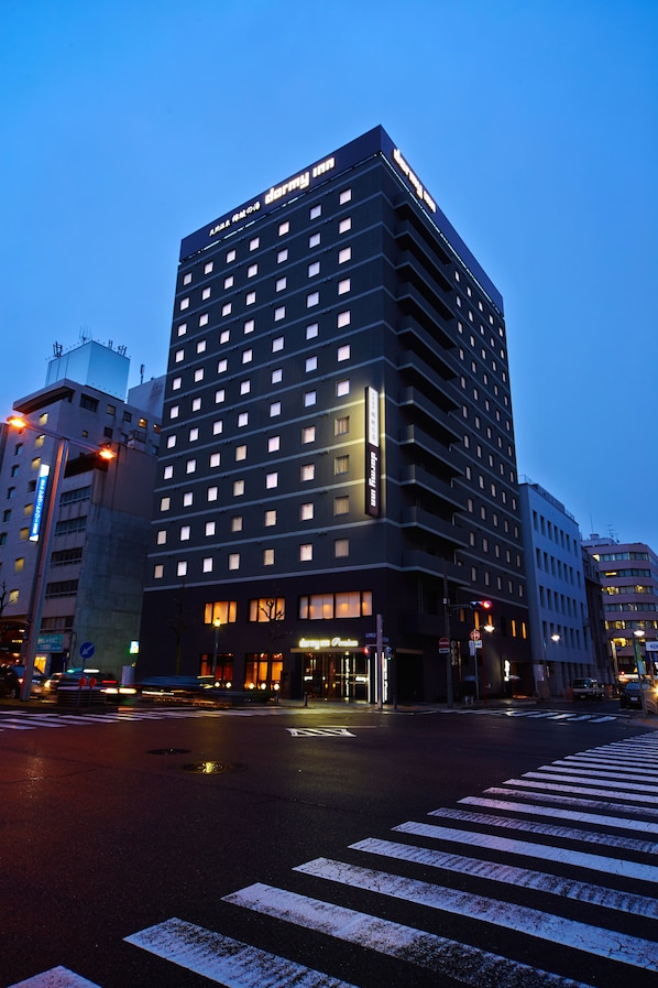 A multi-story hotel with a modern design, featuring a prominent entrance and illuminated signage. - Dormy Inn Premium Nagoya Sakae Natural Hot Spring (Nagoya)