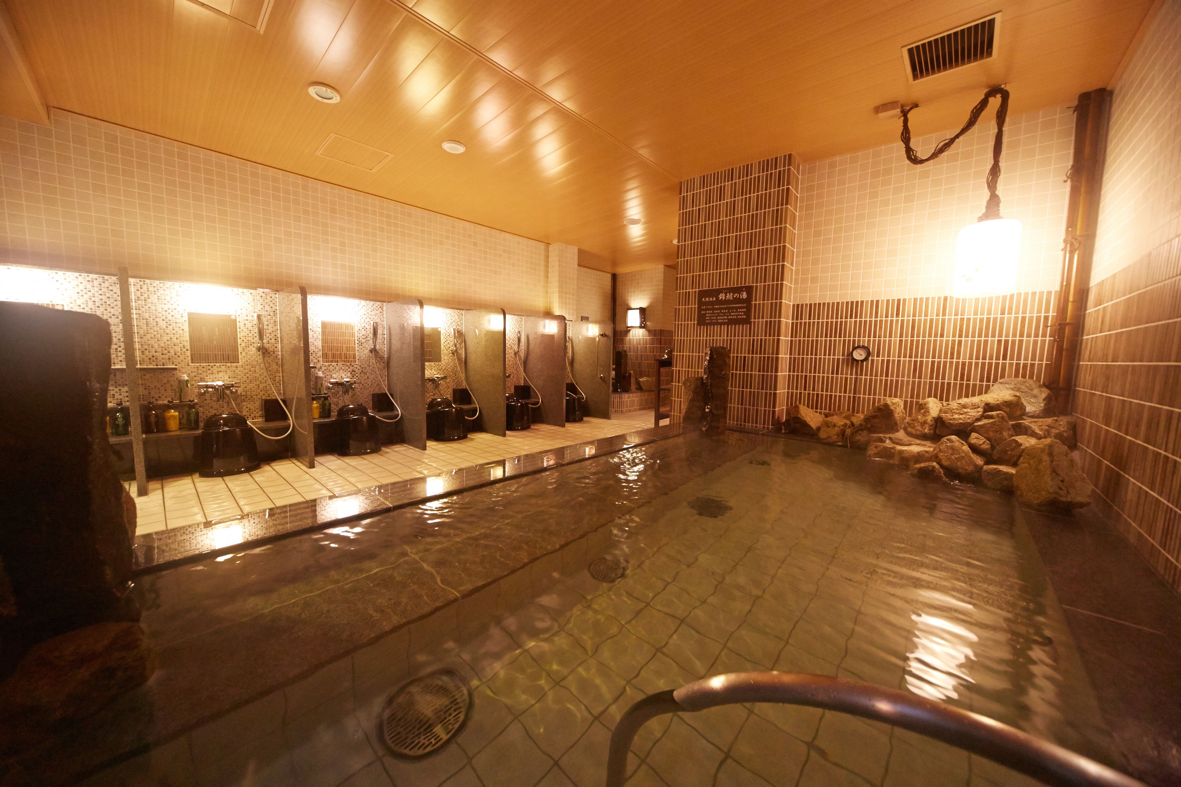 A public bath area with multiple washbasins and a central pool.