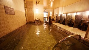 A public bath area with tiled walls, a central water feature, and multiple washbasins. - Dormy Inn Premium Nagoya Sakae Natural Hot Spring (Nagoya)