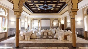 A banquet hall with multiple round tables set for dining, ornate ceiling with a central design, and traditional architectural columns. - Gran Hotel Balneario de Cestona (Zestoa)