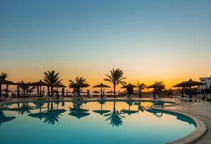 Outdoor pool, pool umbrellas, lifeguards on site