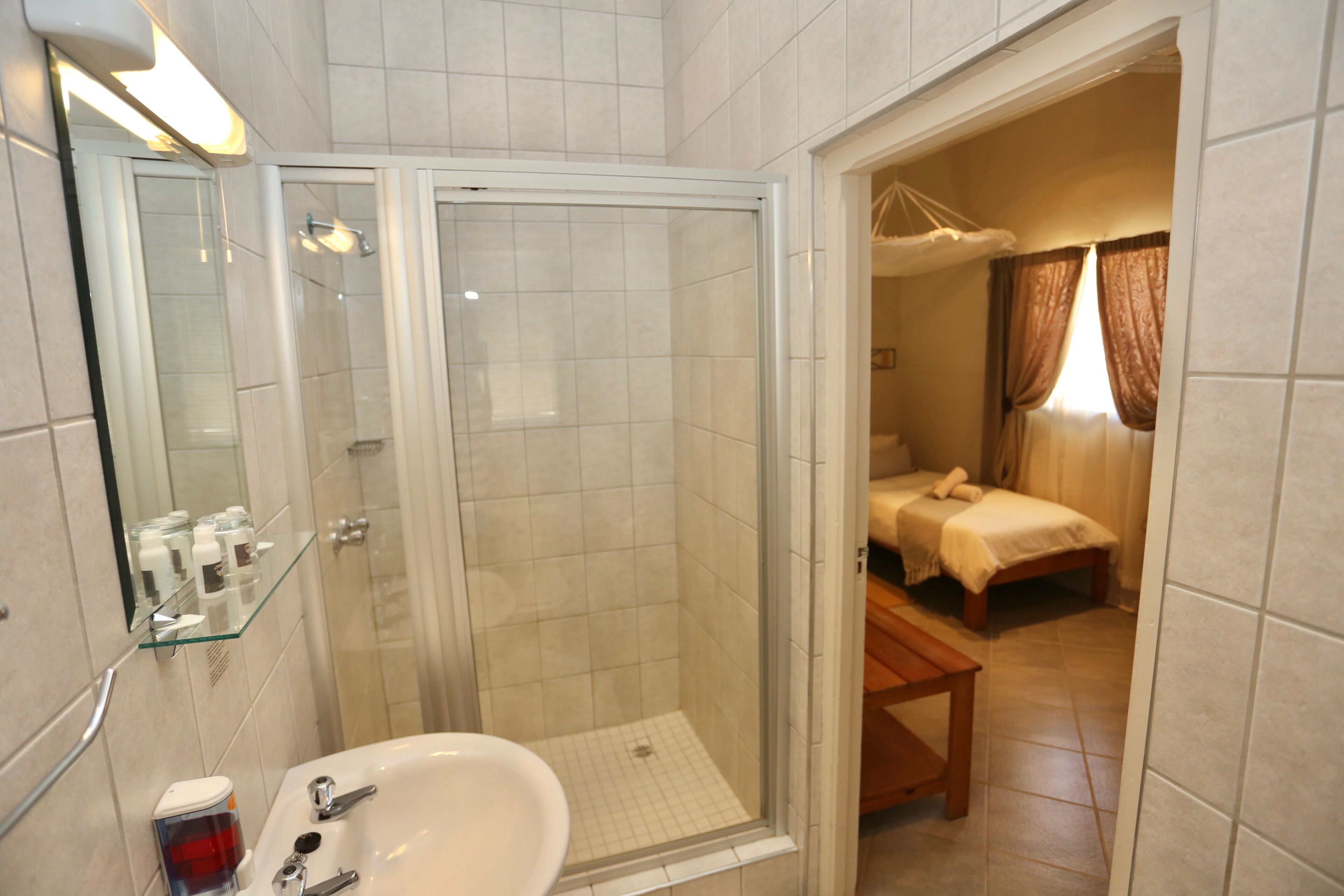 comfort twin room | bathroom | shower, rainfall showerhead, towels, soap