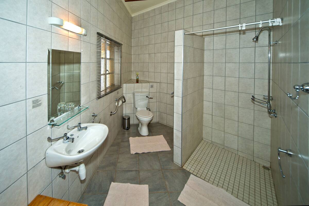 wheelchair friendly room | bathroom | shower, rainfall showerhead, towels, soap