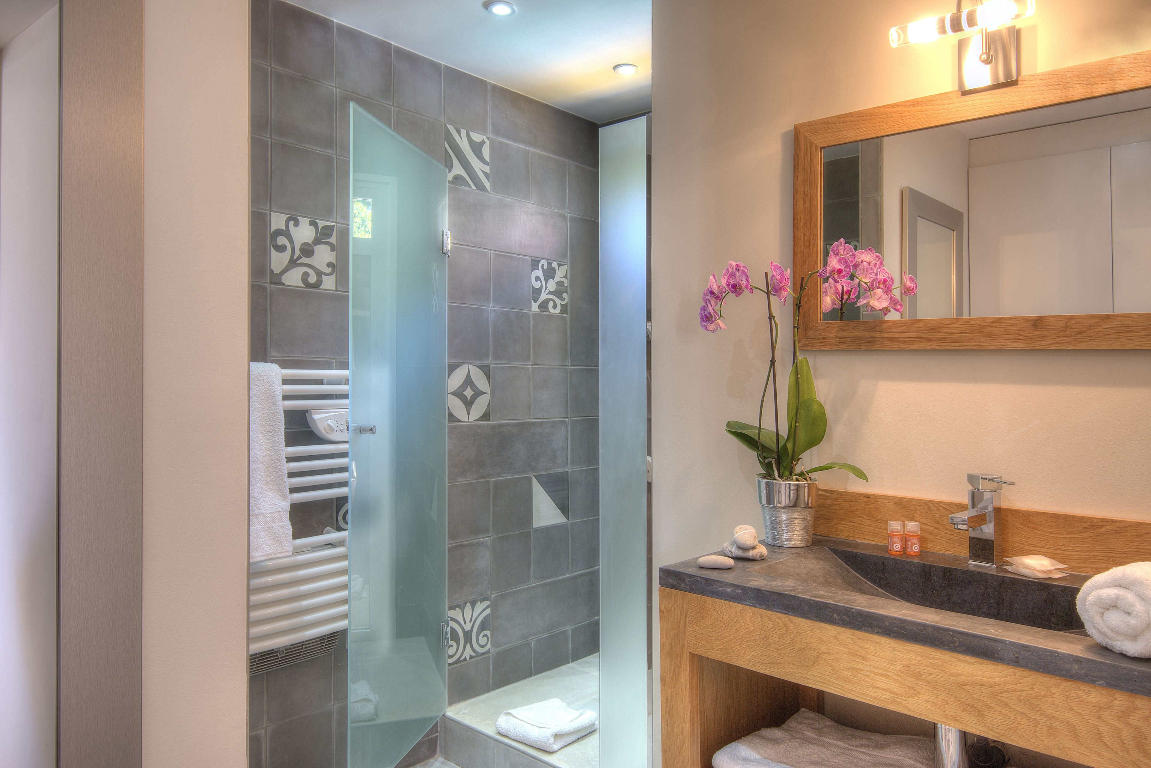 designer toiletries, hair dryer, bathrobes, slippers