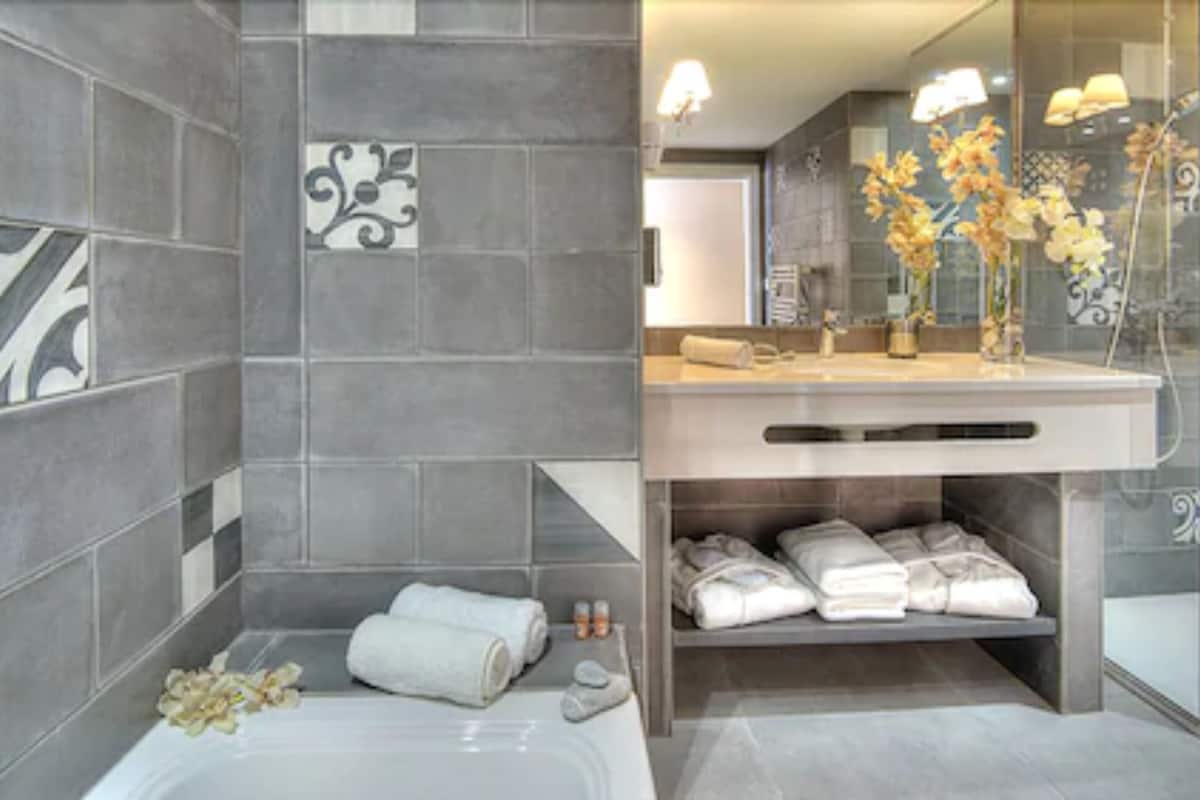 designer toiletries, hair dryer, bathrobes, slippers