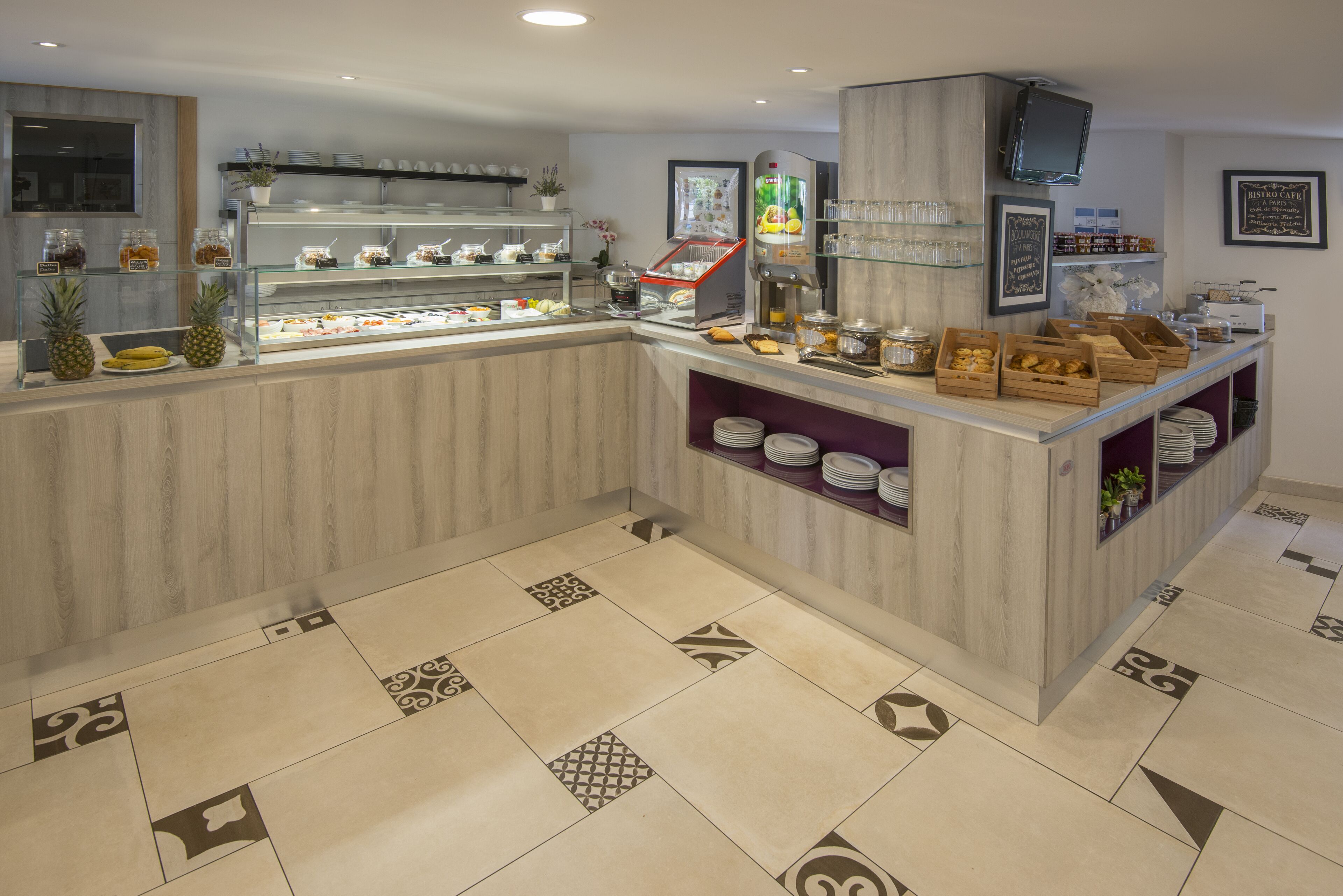 Una barra de desayuno con diversas opciones de comida y una máquina de café.