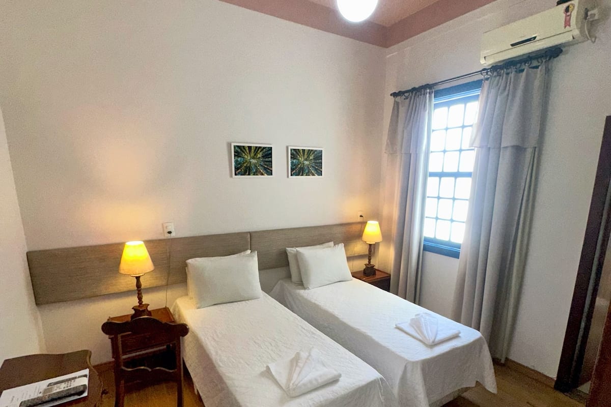 Standard Twin Room | Minibar, desk, laptop workspace, blackout curtains