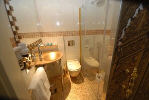 A bathroom with a sink, toilet, and shower. - Galata Palace Hotel (Istanbul)