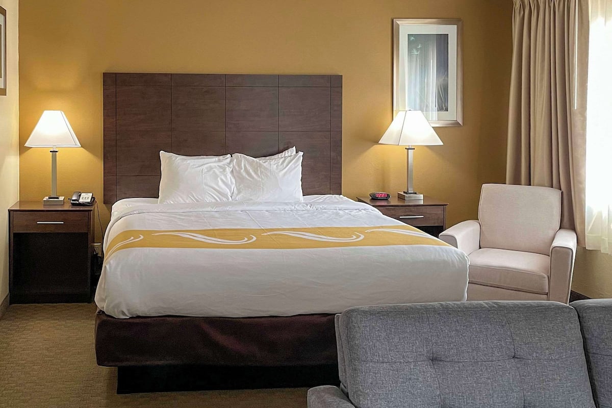 Premium bedding, desk, laptop workspace, blackout drapes