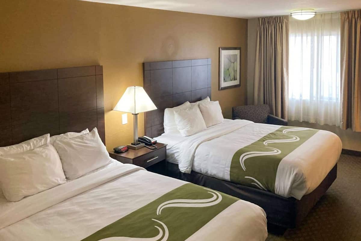 Premium bedding, desk, laptop workspace, blackout drapes