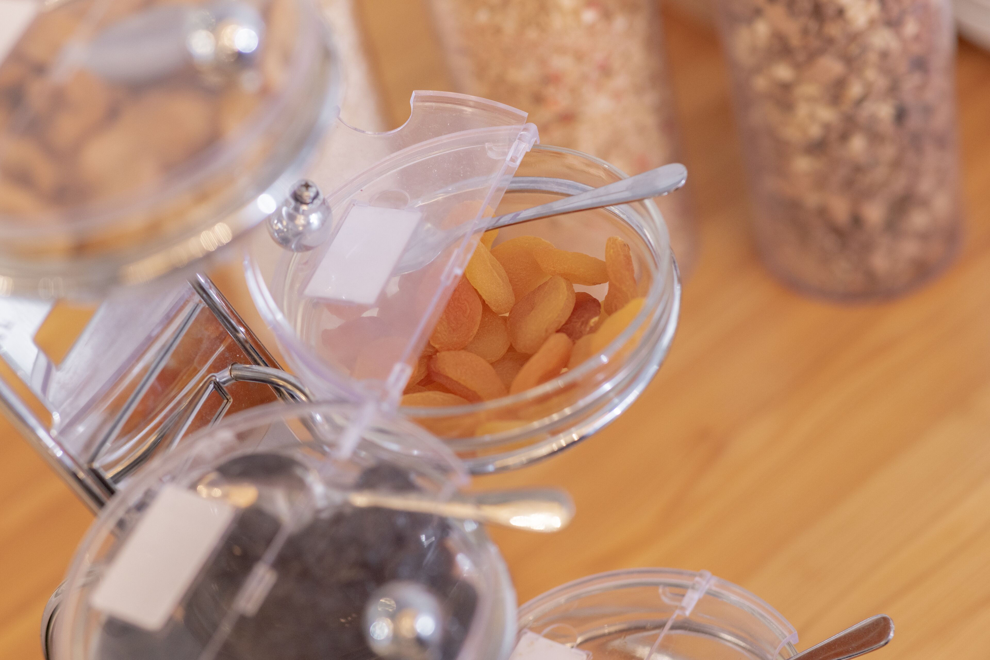 A food processor with various ingredients in transparent containers.