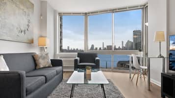 Deluxe Apartment, 1 Bedroom, River View | Living room | Flat-screen TV