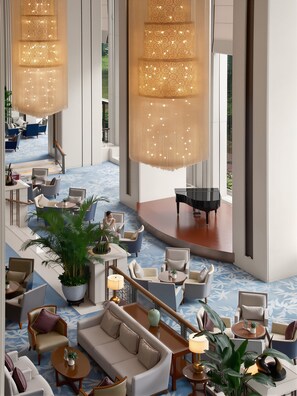 A spacious lobby with a grand piano, multiple seating areas, and large hanging chandeliers. - Shangri-La Nanchang (Nanchang)