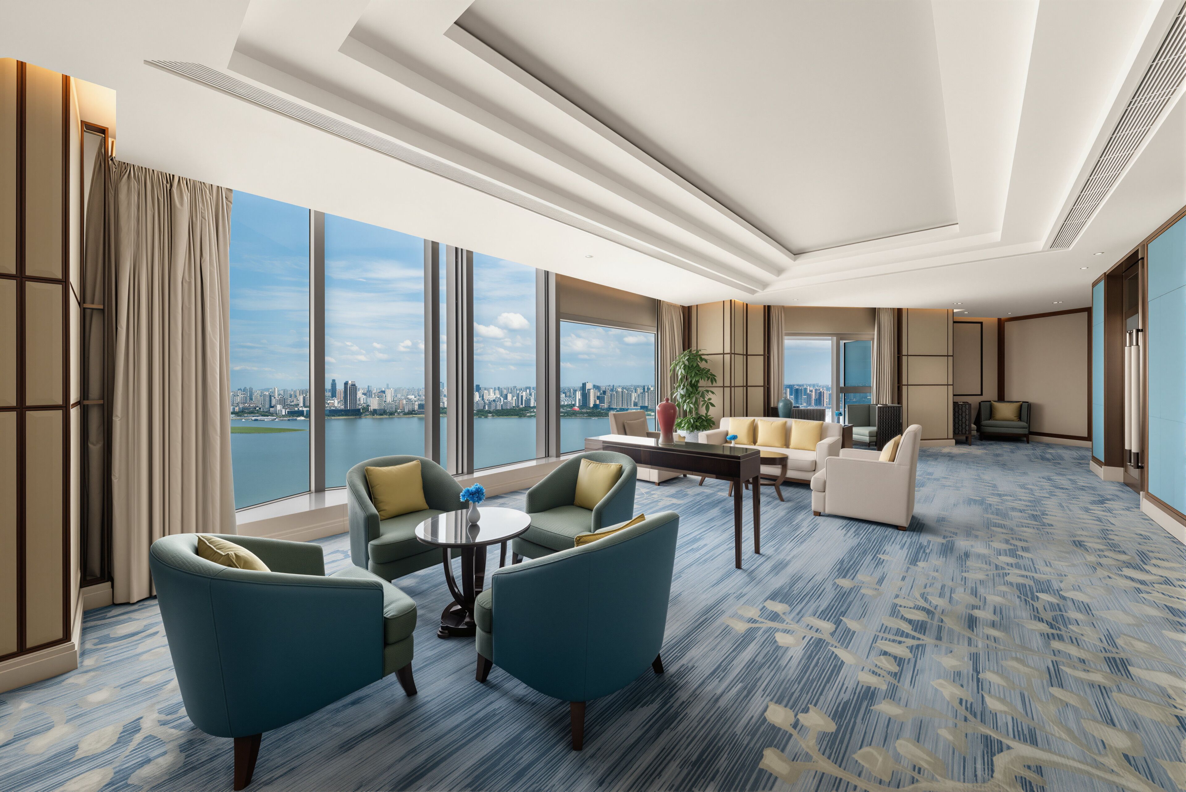 A spacious hotel room with a city view, a large window, and a blue patterned carpet.