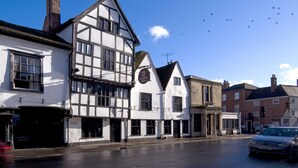 A traditional half-timbered building with a sign indicating a pub. - The Chapter House (Salisbury)