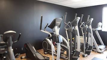 A gym with multiple stationary bikes and treadmills.