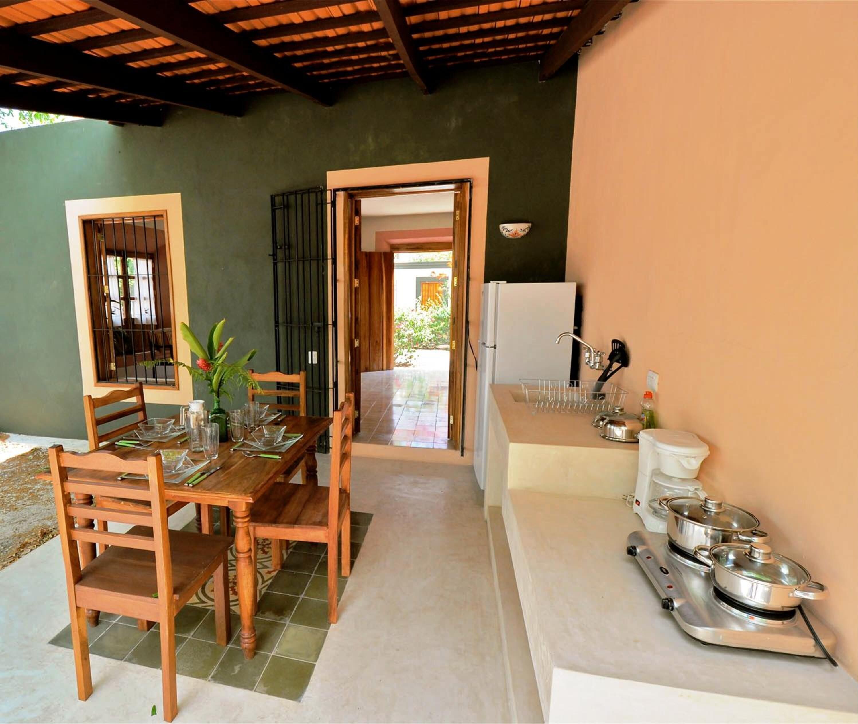 fridge, coffee/tea maker, cookware/dishes/utensils, dining tables