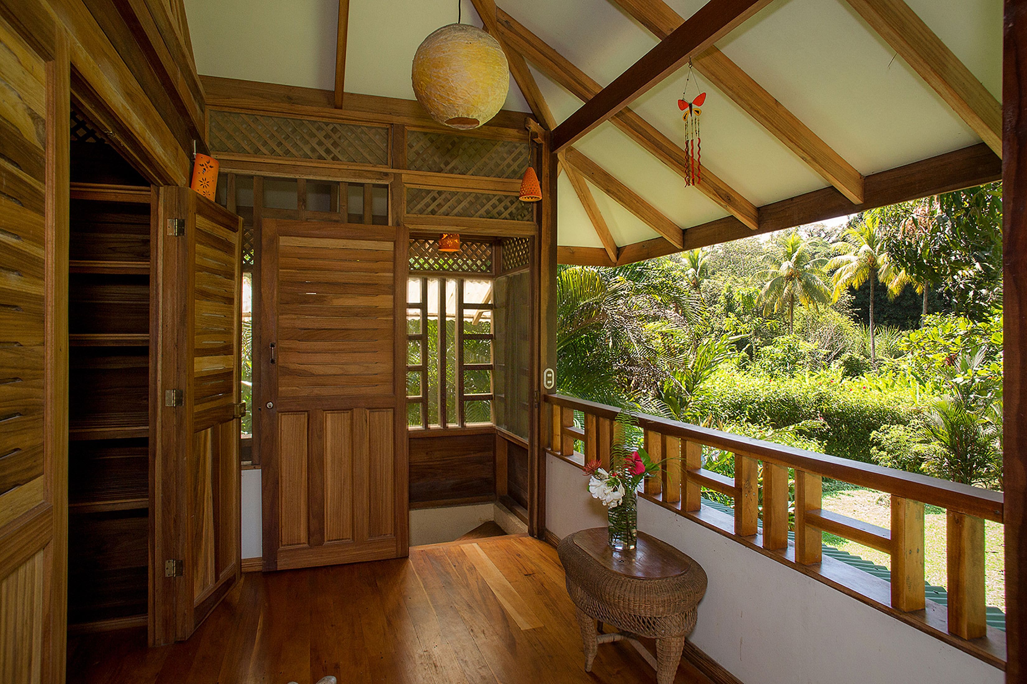 A wooden interior with a view of lush greenery outside.