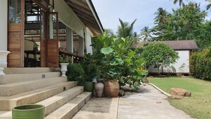 A house with a porch, steps, and potted plants. - Isle Beach Resort (Krabi)