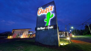 A large illuminated sign for 'The Oasis' with a cactus graphic, located at a resort named 'Chic Resort - Krabi'. - The Oasis Resort (Krabi)
