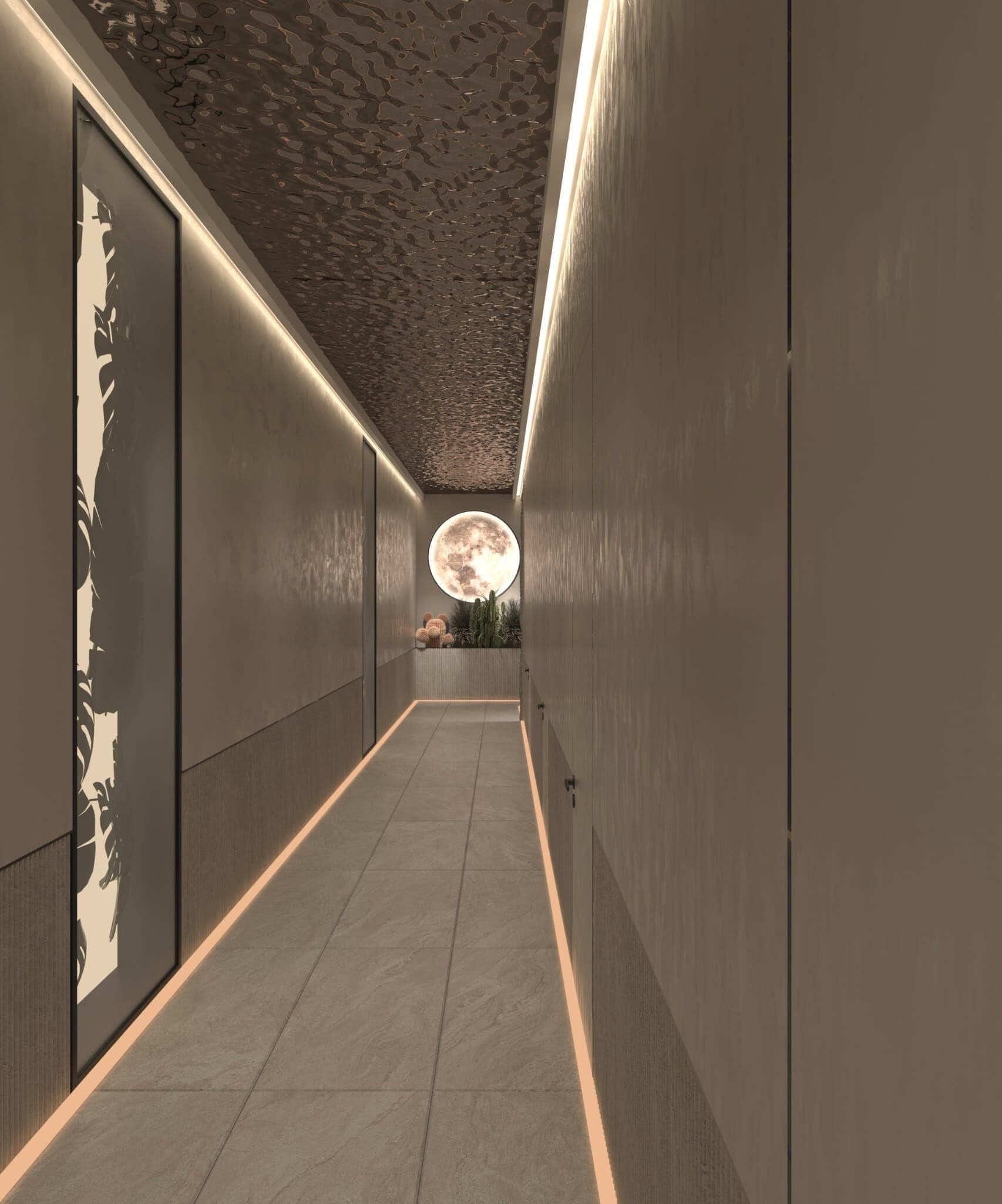 A corridor with a textured ceiling, a circular moon-like light fixture, and a tiled floor.