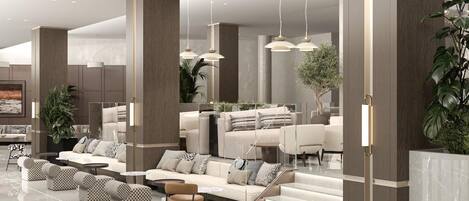 A spacious lobby with a modern design, featuring a seating area with sofas and chairs, a staircase, and a large mirror reflecting the space.