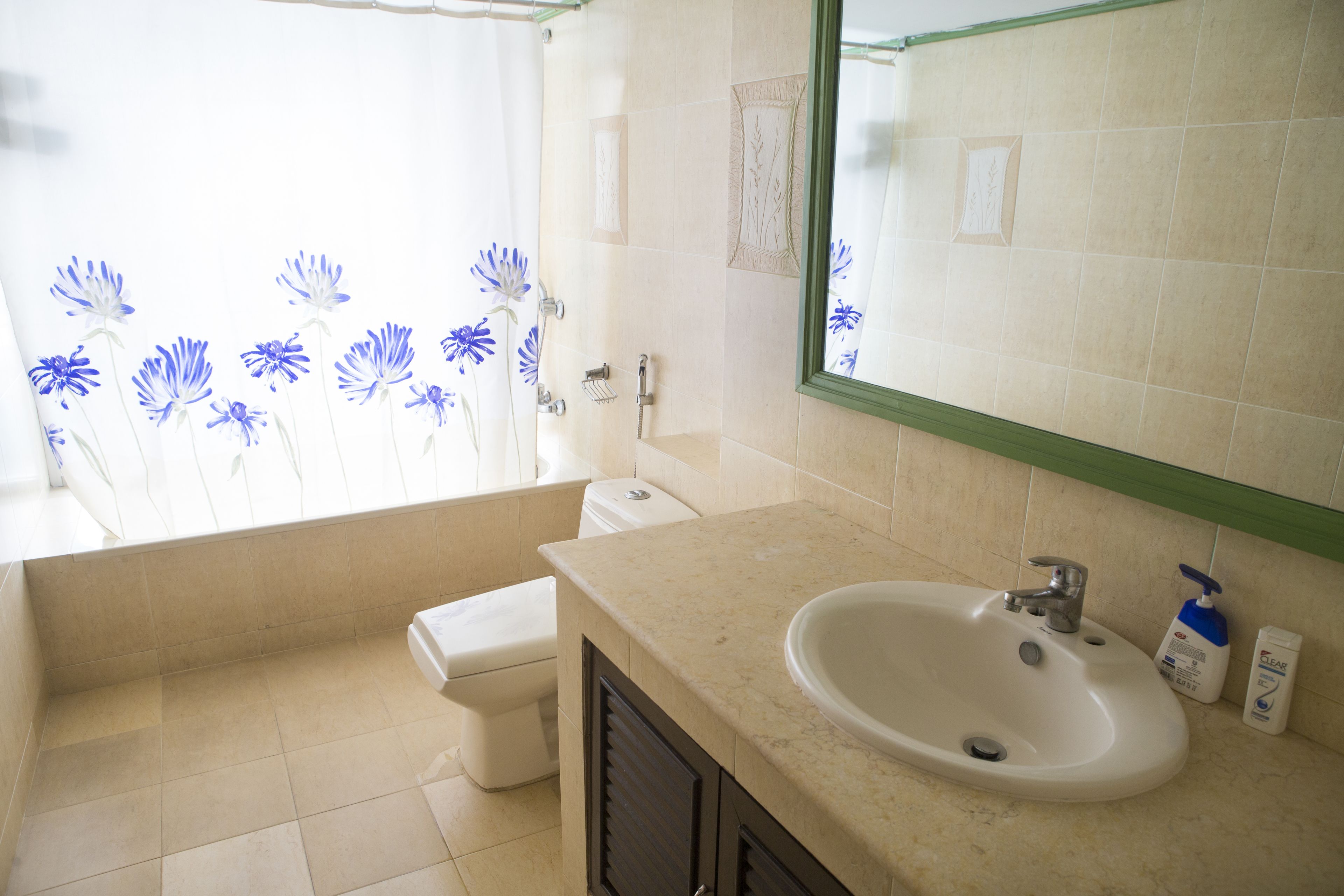 A bathroom with a sink, toilet, and shower.