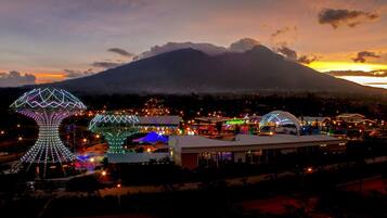 A resort with illuminated structures and a mountain backdrop.