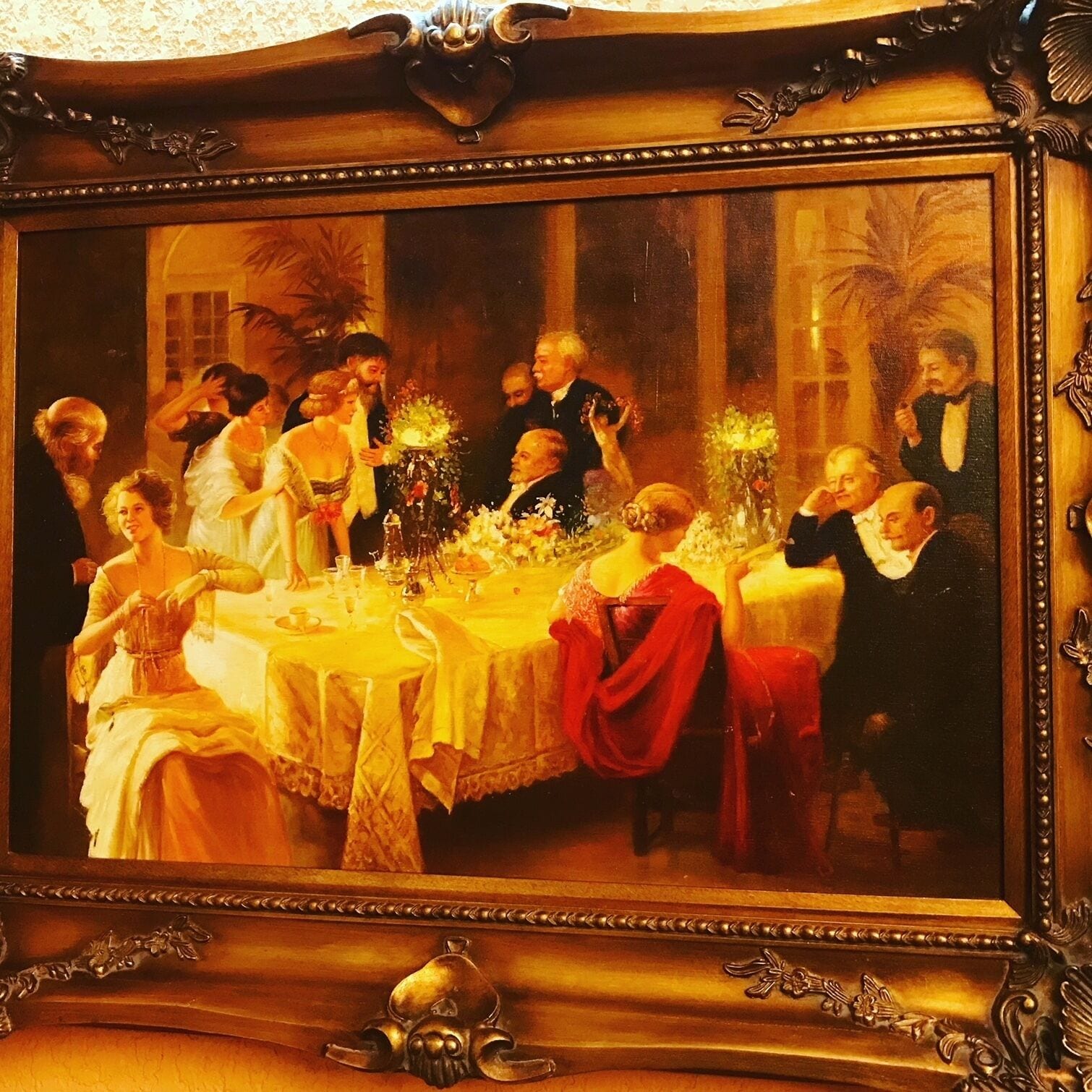 A formal dining room with a large table, ornate furniture, and a decorative mirror.