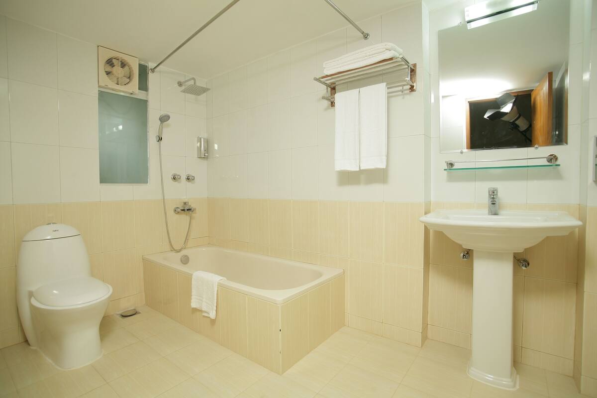 designer toiletries, hair dryer, slippers, towels