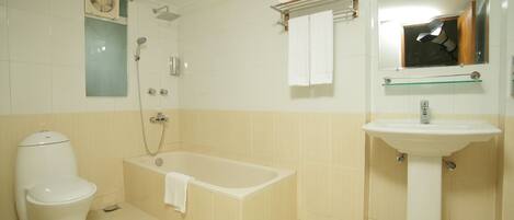 A bathroom with a toilet, bathtub, and sink.