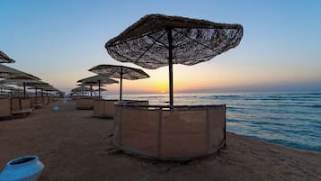 Praia particular, espreguiçadeiras, guarda-sóis, toalhas de praia