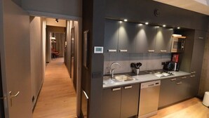 Een moderne keuken met roestvrijstalen apparatuur, een inbouwoven en een magnetron.