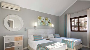 A bedroom with two beds, a dresser, a mirror, and a window with curtains. - Ona Las Brisas (Yaiza)