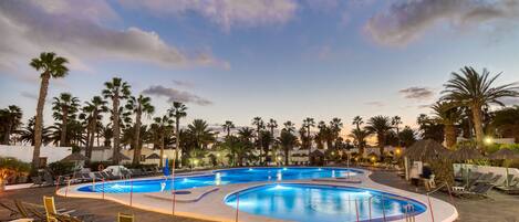 Alberca al aire libre y camastros