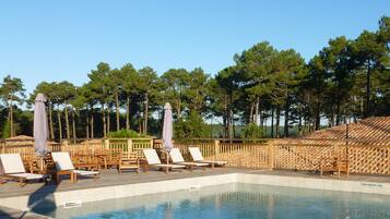 Seasonal outdoor pool, open 10:00 AM to 9:00 PM, pool umbrellas