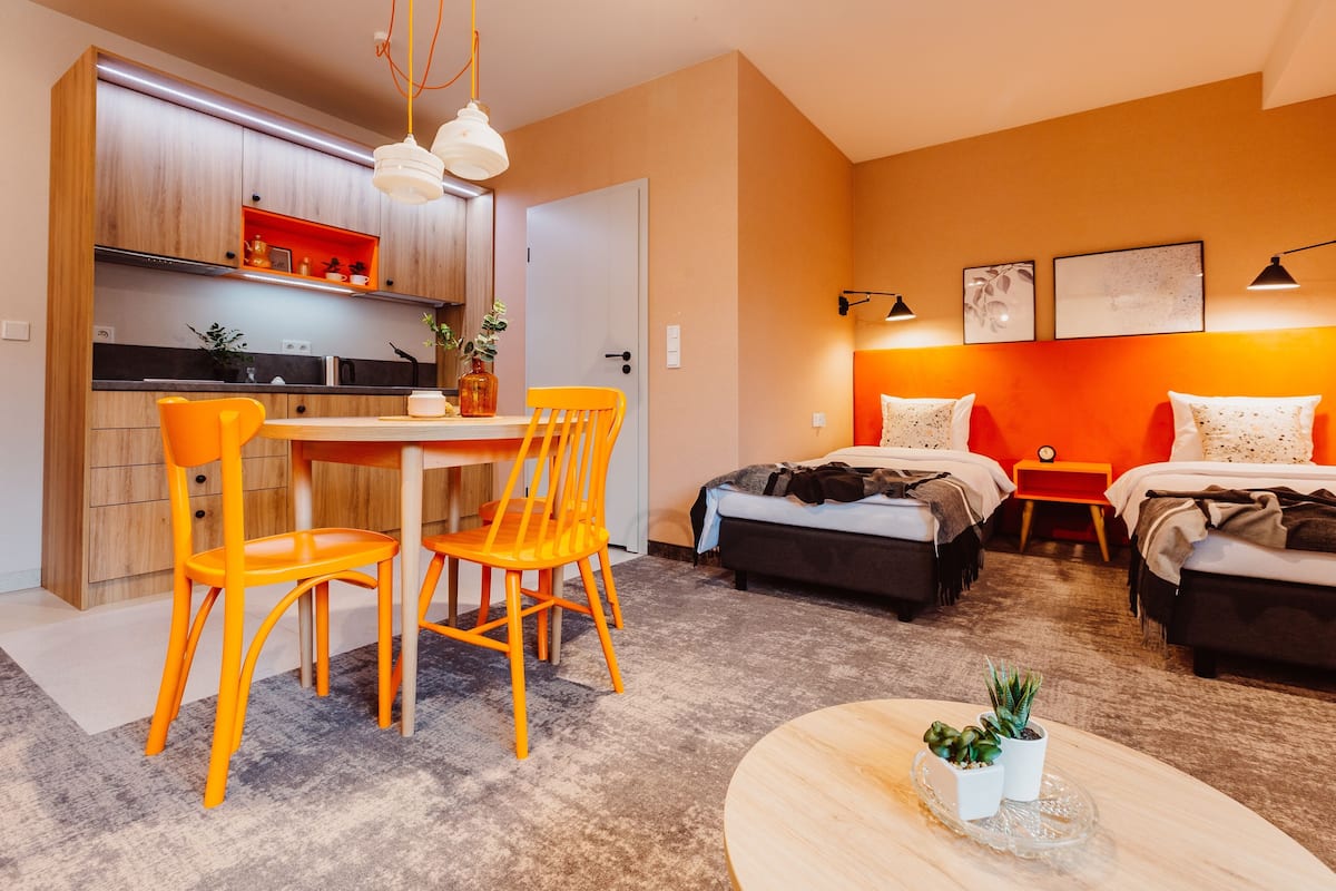 A compact living space with a kitchen, dining area, and two bedrooms.